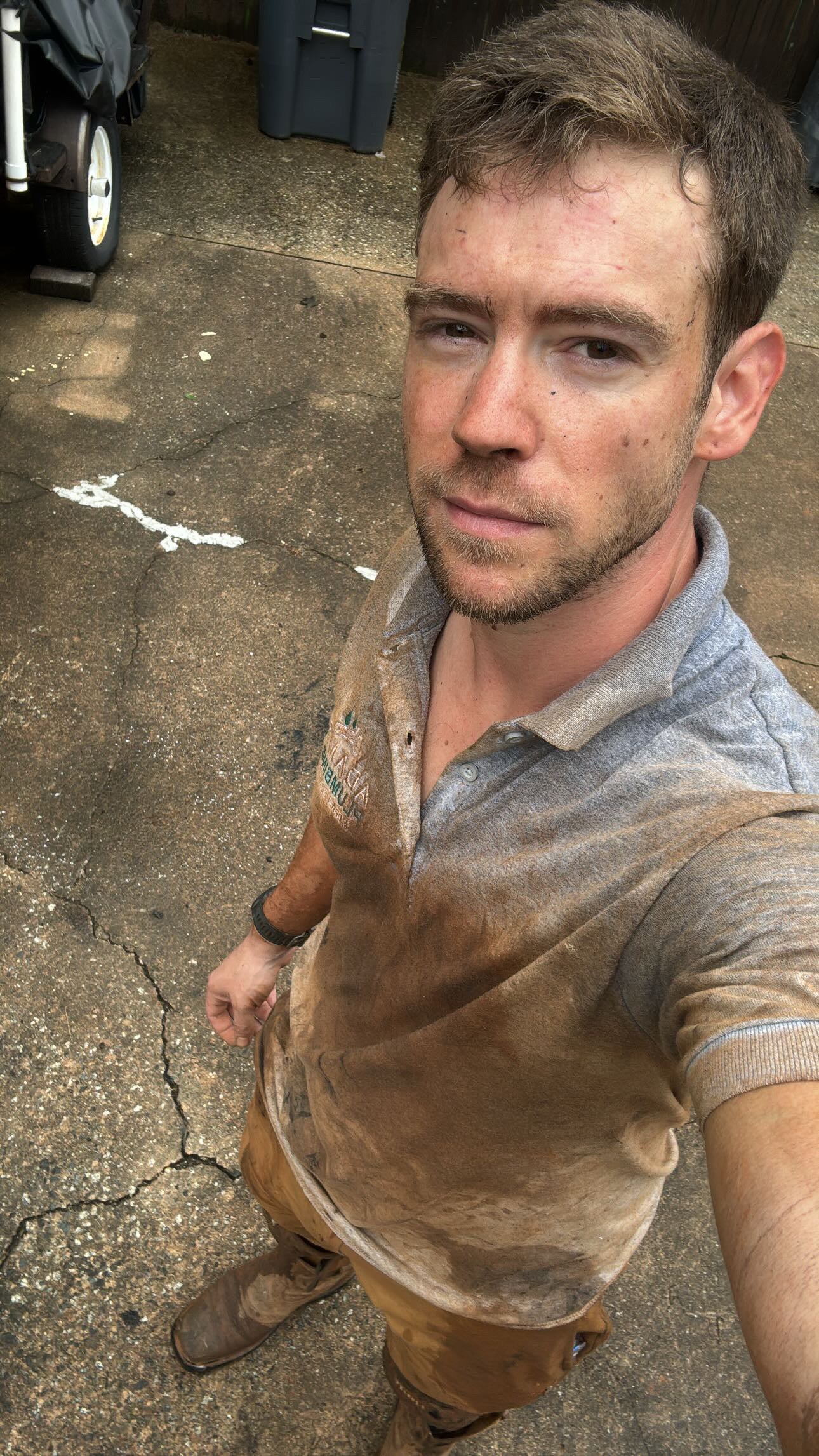 Adam Holder on a job site after diagnosing a plumbing problem