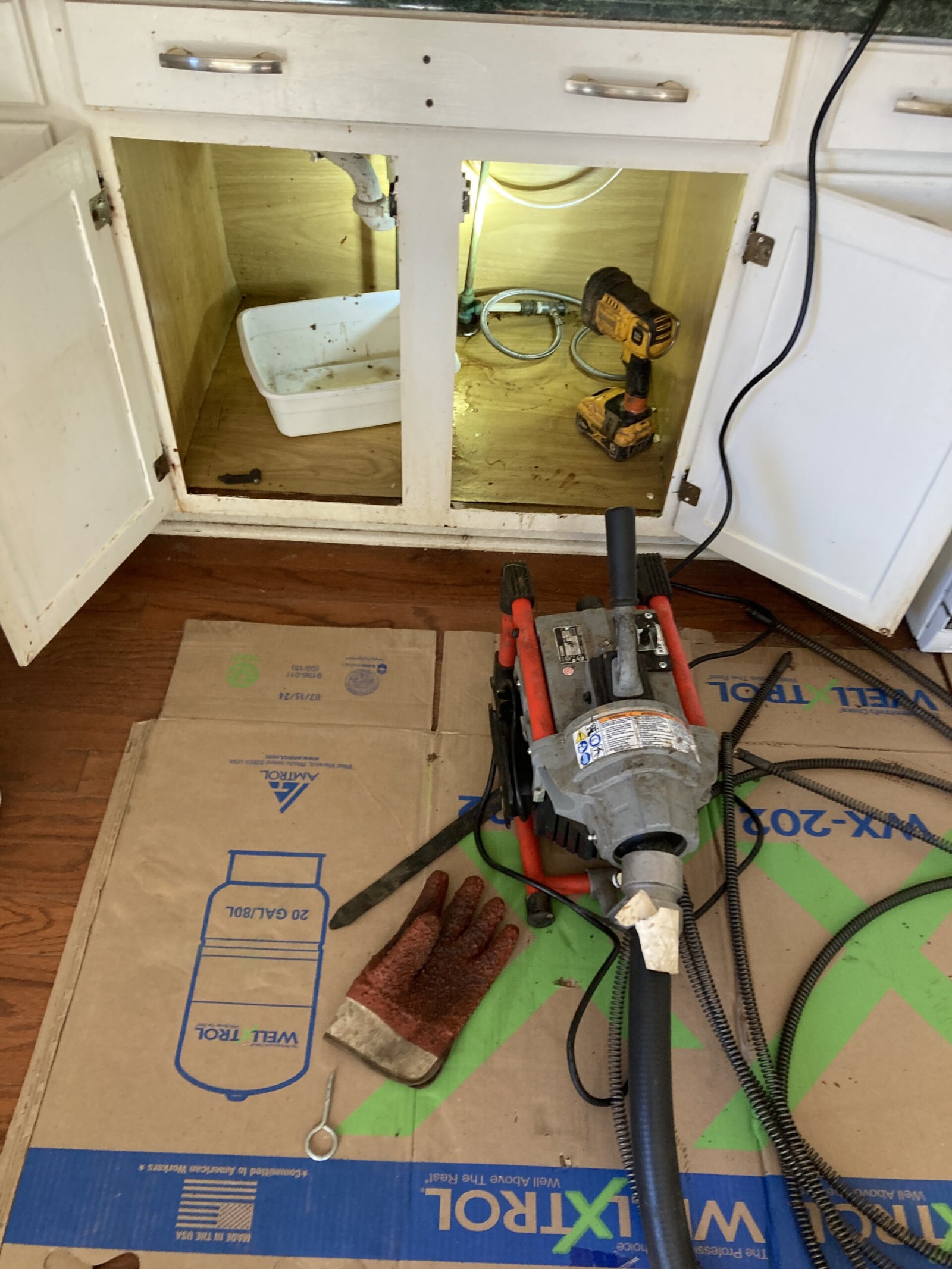 Drain machine set up for a sink drain cleaning