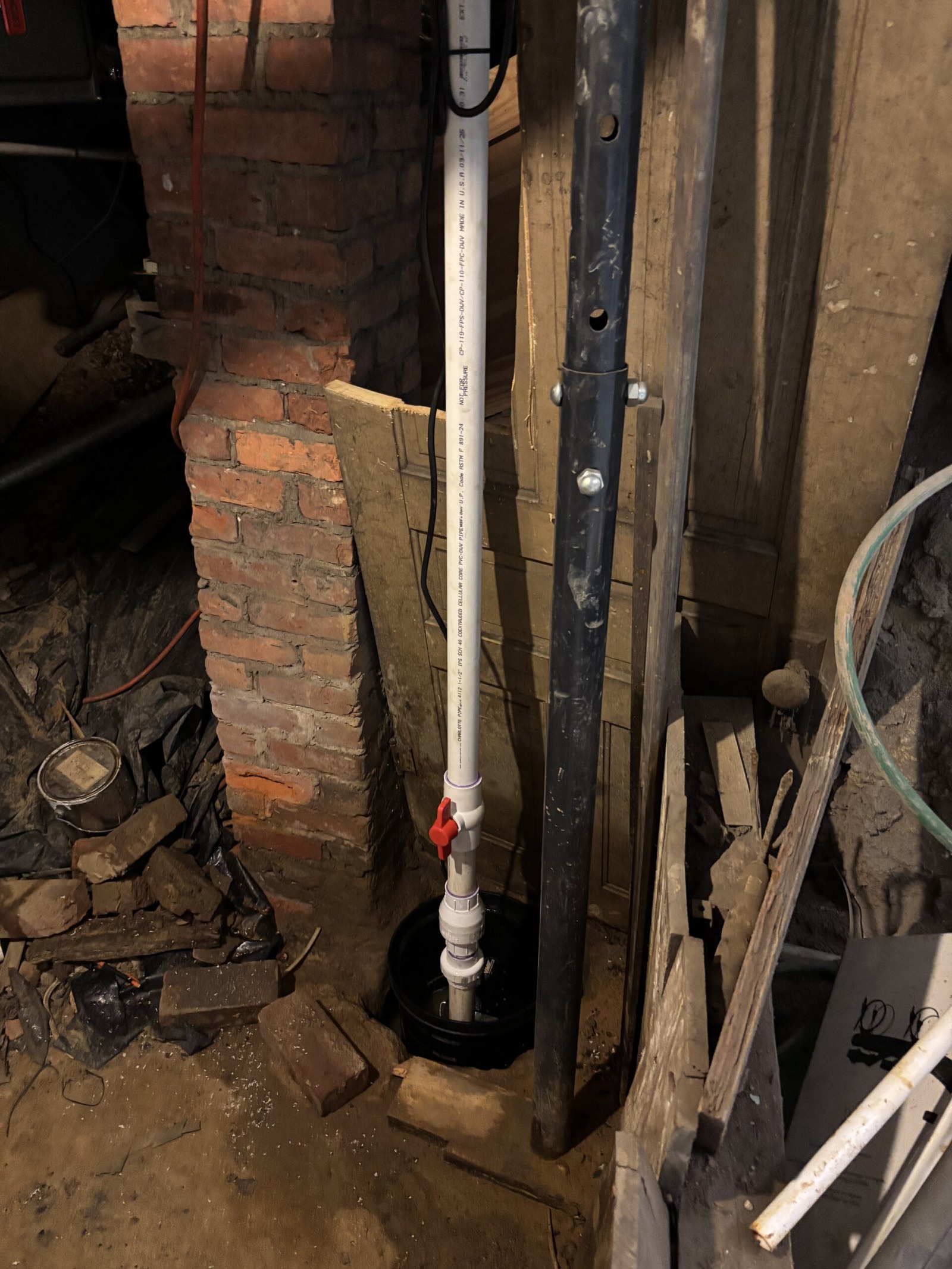 Exposed drain and supply lines opened up for a leak repair
