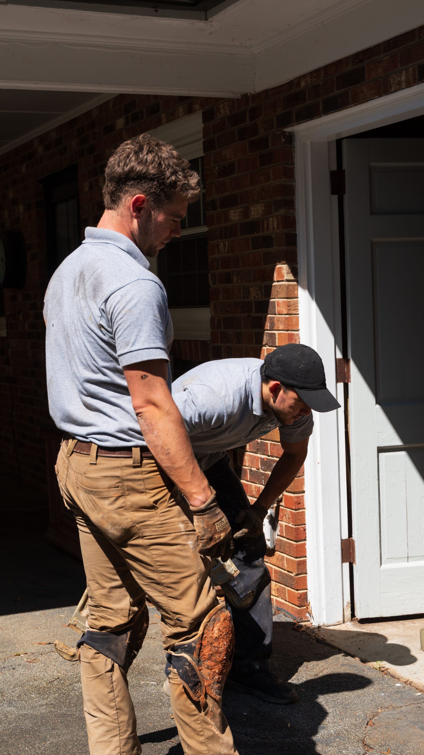 Adam's Plumbing crew starting work at a customer's front door