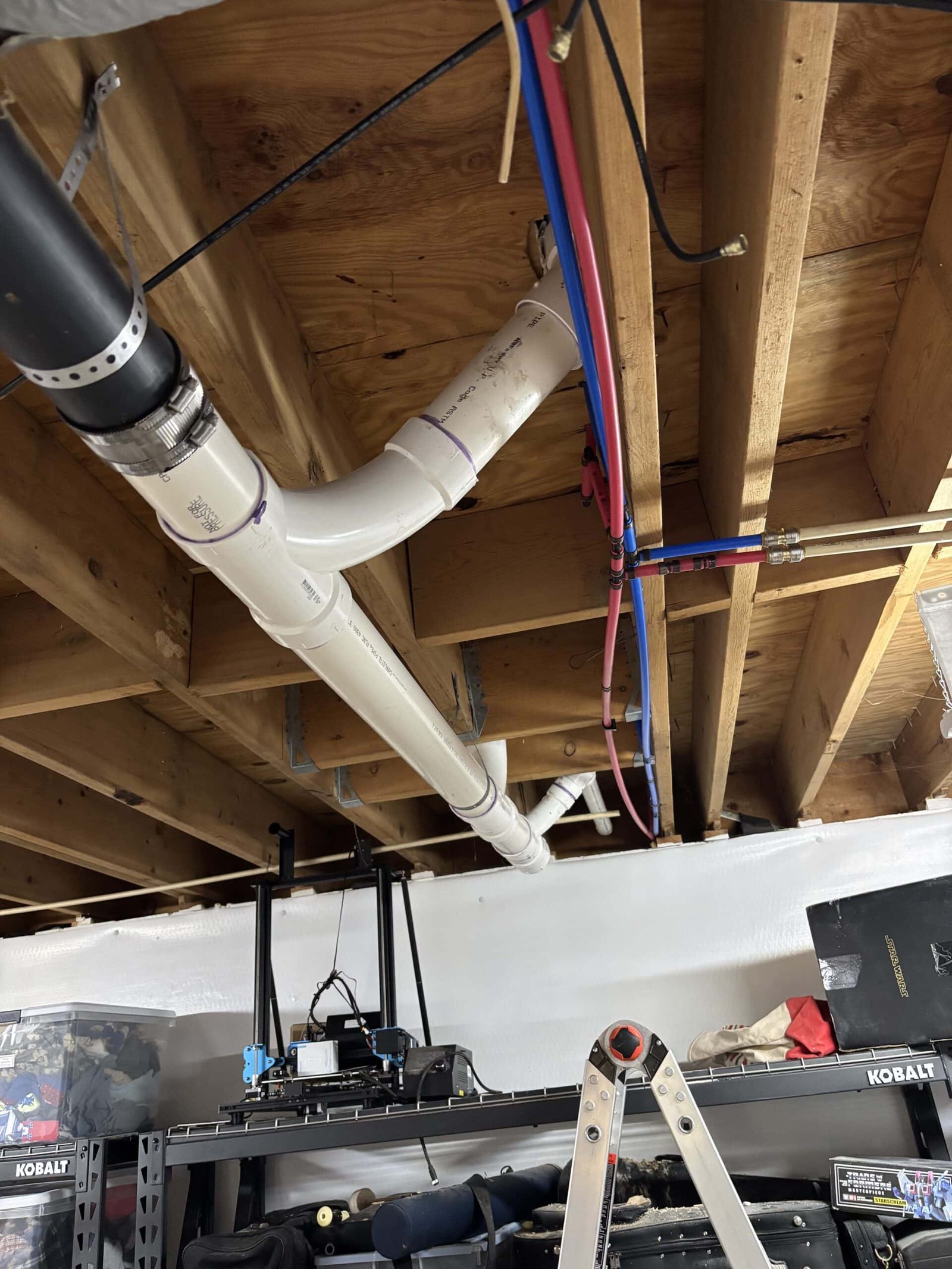 New PVC drain and vent lines run beneath a home